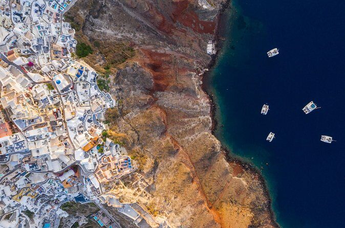 Experience Santorini Sunset by Helicopter - Akrotiri from above: the red cliffs and the feel of an ancient site