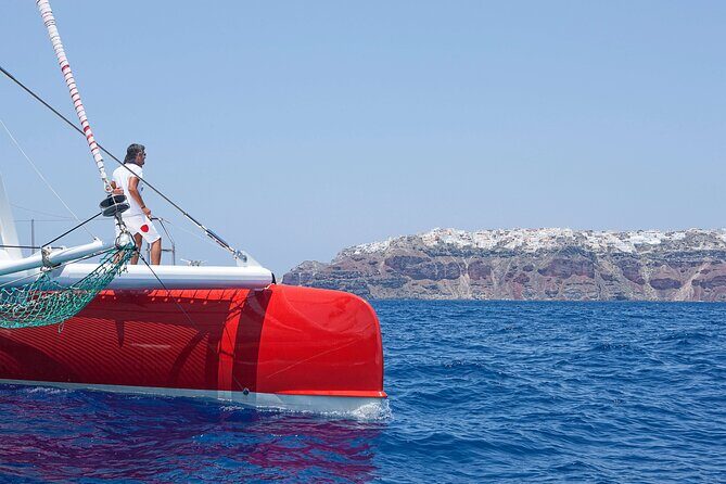 Santorini Cruise on Catamaran with BBQ & Open Bar - Red Beach photo time with real swim-and-snorkel access