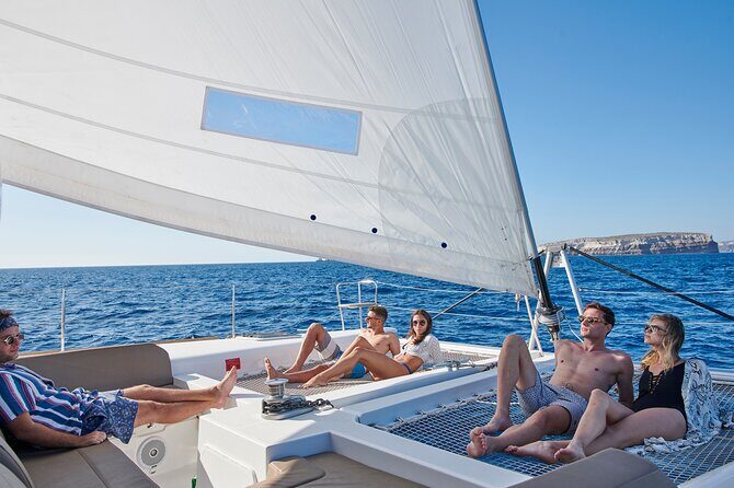 Santorini Platinum Catamaran Cruise with Meal, BBQ and Open Bar - White Beach Sailing Moment and the Akrotiri Lighthouse Photos