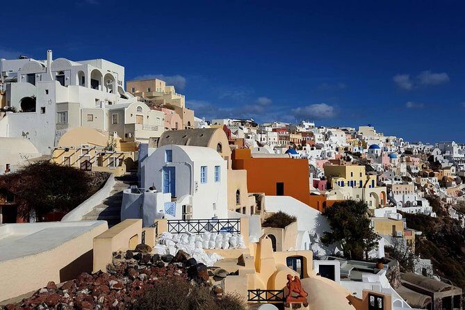 Santorini Private Romantic Tour with Dinner & Wine Tasting - Three Bells of Fira and the Blue Dome selfie with volcano backdrop